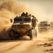 military vehicles on dusty road
